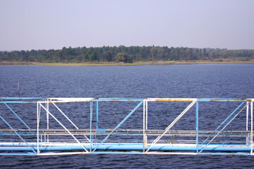Image of a pipe line created in the middle of a blue lake