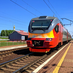 Fototapeta na wymiar Red train at the stop belfry russia