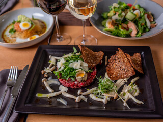 Beef tartar with mushrooms and toast meal 