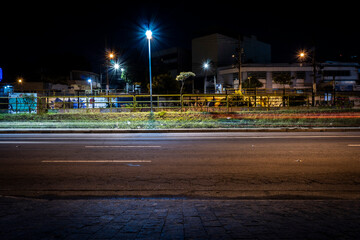 night view of an avenue on the poor outskirts of Sao Paulo city - obrazy, fototapety, plakaty