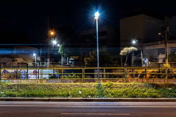 Fototapeta na wymiar night view of an avenue on the poor outskirts of Sao Paulo city