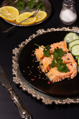 Trout baked in foil with lemon on the table