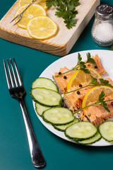 Trout baked in foil with lemon on the table