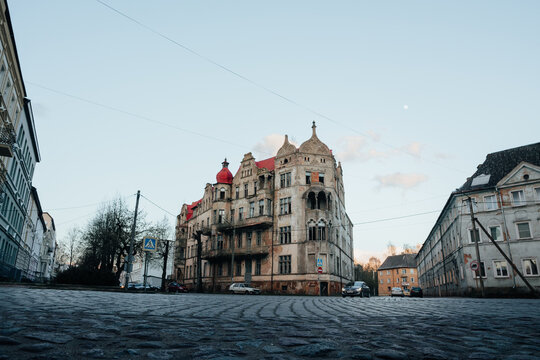 An old historic abandoned house with turrets and decorative ornaments on the facade. One of the main attractions of the city of Sovetsk, Kaliningrad Region