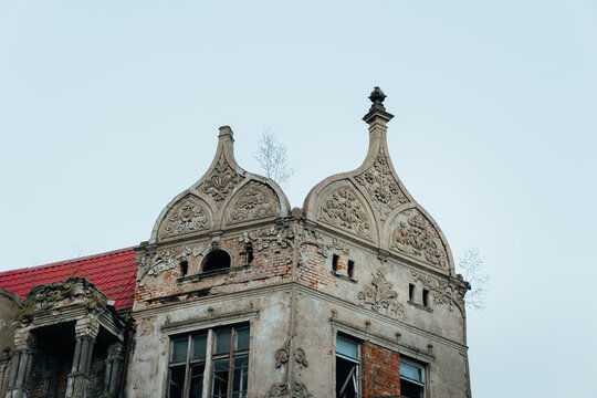 An old historic abandoned house with turrets and decorative ornaments on the facade. One of the main attractions of the city of Sovetsk, Kaliningrad Region