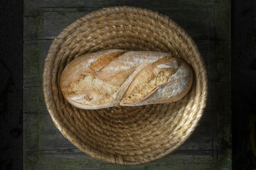 A Loaf of Bread On a Wooden Table in a Wicker Basket