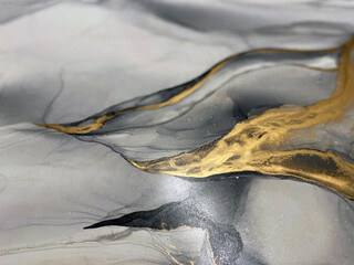 Abstract grey art with gold — black and whited background with beautiful smudges and stains made...