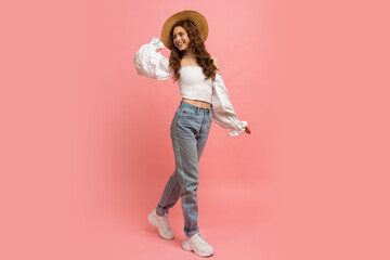 Full lenght image of Ppayful  woman in elegant linen top with balloon sleeves  and blue jeans...