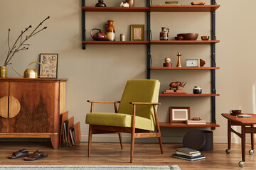 Modern retro concept of living room interior with stylish armchair, wooden shelf, book, picture frame, decoration and elegant personal accessoreis in home decor. Template. Neutral background wall.