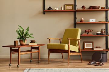 Stylish composition of retro living room interior with design armchair, wooden bookcase, coffee table, picture frames, plant, carpet, slippers, decoration and elegant accessories in home decor. 