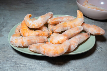 Frozen Tasty Shrimps background..Prawns in ice, healthy seafood, close up photo. Food preparing.