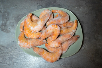 Frozen Tasty Shrimps background..Prawns in ice, healthy seafood, close up photo. Food preparing.