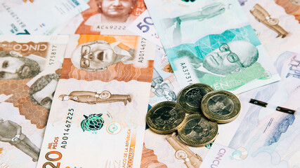 olombian money of different denominations with coins