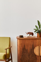 Vintage concept of living room interior with retro armchair, wooden commode, plant, book and cupof coffee. Copy space. Template.