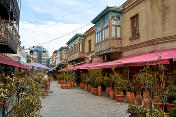 Street landscape of the old city of Tbilisi. Soul and atmosphere of Georgia. A deserted street, free tables in a cafe. Coronavirus pandemic