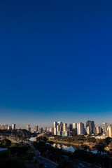Fototapeta premium City skyline, with Marginal Avenue and Pinheiros River in the foreground, in the south zone of Sao Paulo, Brazil