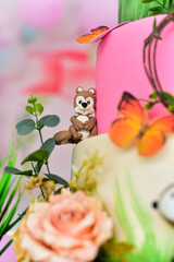 birthday cakedecorated with bear, butterfly and flowers, themed cake