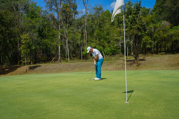Golfers are putting golf in the evening golf course golf backglound. Golfer hitting golf ball....