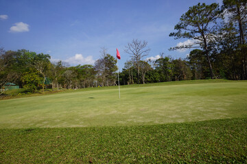 Obraz premium Landscape of a beautiful golf course at the sunset in the countryside.