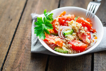 couscous salad tomato, onion, cucumber, spices vegetables appetizer fresh portion organic on the table healthy food meal snack copy space food background rustic. top view keto or paleo diet
