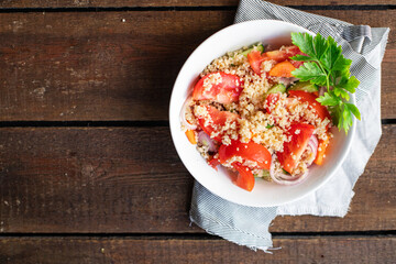 couscous salad tomato, onion, cucumber, spices vegetables appetizer fresh portion organic on the table healthy food meal snack copy space food background rustic. top view keto or paleo diet