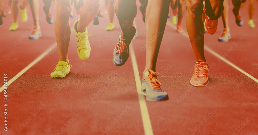 Wall mural Composition of group of fit people running over light blur