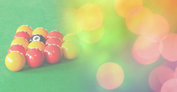 Composition of snooker balls on snooker table with orange and yellow spots in background