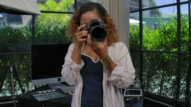 Woman Photographer process image and footage on computer