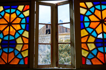 Authentic balcony of an old residential building with a stained glass window made of multicolored mosaics