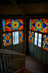 Fototapeta na wymiar Authentic balcony of an old residential building with a stained glass window made of multicolored mosaics