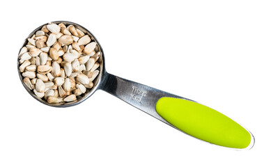 Safflower seeds in measuring tablespoon cutout