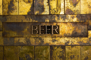 Beer text on grunge textured copper and gold background