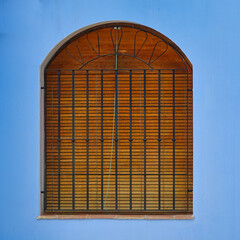 Wooden window in a blue wall