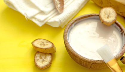 Homemade banana cosmetics. Cosmetic face mask with banana, oatmeal, honey, yolk. Natural skin care, wellness cosmetics,close-up. Diy banana mask,zero waste concept