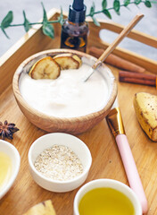 Homemade cosmetic cream with banana from natural ingredients. Banana face mask at home for wellness skin and body care. Diy natural cosmetics concept background