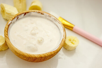 Homemade banana cosmetics. Cosmetic face mask with banana, oatmeal, honey, yolk. Natural skin care, wellness cosmetics,close-up. Diy banana mask,zero waste concept