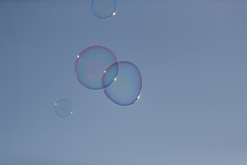 soap bubbles against blue sky