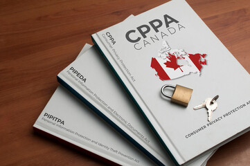 Canada new data protection law (cppa) concept: three books shows the name of the old and the new Canada data protection laws