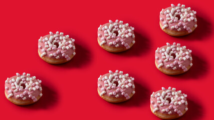 Donut with pink glazed and marshmallow topping on red background. Pattern image