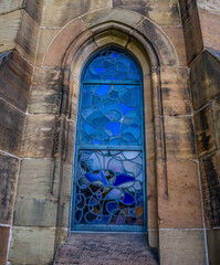 Beautiful Church window with reflectiv blue curvy patterns