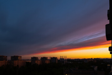 beautiful flaming sunset, the setting sun over the city falling asleep in the twilight, fantastic colors and shades that nature draws,sunrises sunsets