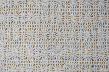 Background from a knitted ornament of white threads.