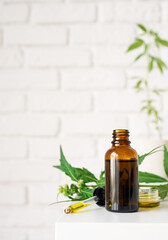 cbd oil and cannabis leaves cosmetics front view