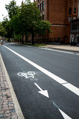 Freshly build bicycle lane in the city,Bike path. Sign white paint on the pavement. Summer. bicycle traffic sign painted on the asphalt.