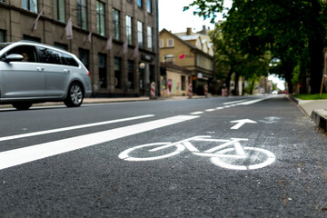 Freshly build bicycle lane in the city,Bike path. Sign white paint on the pavement. Summer. bicycle traffic sign painted on the asphalt.