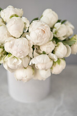 White Odile peonies in a metal vase. Beautiful peony flower for catalog or online store. Floral shop concept . Beautiful fresh cut bouquet. Flowers delivery. Copy space