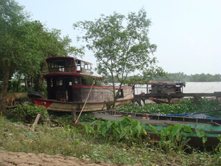 Fototapeta na wymiar Abandoned fishing boats in the Mekong Delta, Vietnam