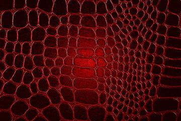 Dark crocodile skin texture in red color. Red reptile leather imitation texture to background.