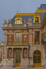 Versailles, France - 19 05 2021: Castle of Versailles. Detail of the golden facade of the Castle of...