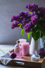 bouquet of purple lilacs on the table in a jug
